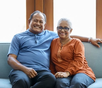 Elderly couple sitting on couch