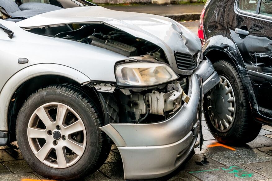 Grey car in a car accident with a black vehicle