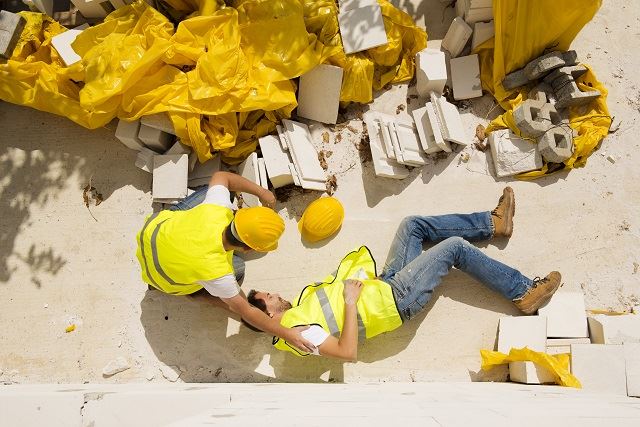 Man on the ground after a construction accident